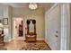 Welcoming foyer with hardwood floors, wooden hall tree, and entry to other rooms at 3230 Riverhill Ct, Cumming, GA 30041