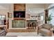 Bright living room with wood floors, built in cabinets, and an open connection to the breakfast bar at 3230 Riverhill Ct, Cumming, GA 30041