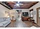 Open living area featuring exposed wood ceiling, wood-look laminate flooring, and leads into other areas of the home at 3230 Riverhill Ct, Cumming, GA 30041