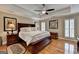 Main bedroom features hardwood floors, a tray ceiling, and windows with wooden shutters at 3230 Riverhill Ct, Cumming, GA 30041