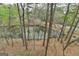 Scenic view of a tranquil pond surrounded by lush trees, showcasing a serene natural environment at 3230 Riverhill Ct, Cumming, GA 30041