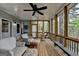 Charming screened-in porch with wicker furniture and natural wood accents, offering serene views of the wooded area at 3230 Riverhill Ct, Cumming, GA 30041