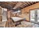 Recreation room features a pool table, stairs, an exposed wood ceiling, and knotty pine planking at 3230 Riverhill Ct, Cumming, GA 30041