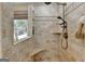 This shower features neutral tiled walls, tiled shower seat and a window letting in natural light at 3230 Riverhill Ct, Cumming, GA 30041
