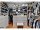 Spacious walk-in closet boasts custom shelves, drawers, hanging rods, and a wooden floor at 3230 Riverhill Ct, Cumming, GA 30041