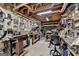 Spacious workshop with pegboard walls, exposed wood ceiling, workbenches, tools, and storage shelving at 3230 Riverhill Ct, Cumming, GA 30041
