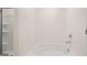 Bright bathtub with white porcelain and chrome faucet, with a shower and door on the left at 8593 Secretariat Dr # 20, Lithonia, GA 30058