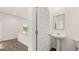 Powder room with pedestal sink and mirror, located next to a doorway into the living area at 8593 Secretariat Dr # 20, Lithonia, GA 30058