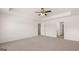 Open bedroom featuring neutral carpet, ceiling fan and walk-in closet at 8593 Secretariat Dr # 20, Lithonia, GA 30058