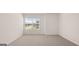 Empty bedroom with wall to wall carpeting and large window at 8593 Secretariat Dr # 20, Lithonia, GA 30058
