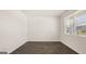 A bedroom with wood floors and a large window, with neutral wall paint at 8593 Secretariat Dr # 20, Lithonia, GA 30058