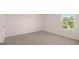 Neutral bedroom with carpet and window overlooking green space at 8593 Secretariat Dr # 20, Lithonia, GA 30058