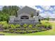 Stone Champions Run community sign surrounded by colorful flowers and lush greenery at 8593 Secretariat Dr # 20, Lithonia, GA 30058