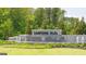Stone community entrance monument with water features surrounded by lush landscaping at 8593 Secretariat Dr # 20, Lithonia, GA 30058