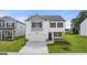 Two-story home featuring black shutters, a two-car garage, and a well-maintained front lawn at 8593 Secretariat Dr # 20, Lithonia, GA 30058