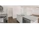 Kitchen island with granite countertop, stainless steel appliances, and a view into the living area at 8593 Secretariat Dr # 20, Lithonia, GA 30058