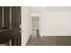 Living room with hardwood floors that extend into the home, and black wood door that leads outside at 8593 Secretariat Dr # 20, Lithonia, GA 30058