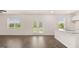 Open-concept living room with hardwood floors, natural light, and view of kitchen island at 8593 Secretariat Dr # 20, Lithonia, GA 30058
