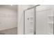 Shower stall with glass doors, shower head and shelving in the wall, with a closet on the left at 8593 Secretariat Dr # 20, Lithonia, GA 30058