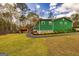 Inviting backyard featuring a lush lawn, grilling shed, and pathway at 168 Lakeview Dr, Grantville, GA 30220