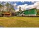 Inviting backyard featuring a lush lawn, grilling shed, and a well-manicured lawn at 168 Lakeview Dr, Grantville, GA 30220