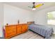 Bedroom featuring a ceiling fan, wood dresser, and natural light from the window at 168 Lakeview Dr, Grantville, GA 30220