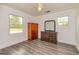 Bedroom featuring hardwood floors and natural light from two windows at 168 Lakeview Dr, Grantville, GA 30220