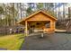 Outdoor grilling shed equipped with cooking appliances, bar, and dining space at 168 Lakeview Dr, Grantville, GA 30220