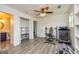 Home gym featuring wood floors, ceiling fan, exercise equipment, and plenty of storage in a bright and airy space at 168 Lakeview Dr, Grantville, GA 30220