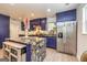 A modern purple kitchen features a marble-top island with seating and stainless steel appliances at 168 Lakeview Dr, Grantville, GA 30220