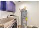 Laundry room featuring modern appliances and upper cabinet at 168 Lakeview Dr, Grantville, GA 30220