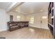 A large living room features a leather sofa, light wood flooring, and neutral walls and trim at 168 Lakeview Dr, Grantville, GA 30220