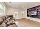 A living room features a leather sofa, wood flooring, neutral walls and trim, and a mounted TV at 168 Lakeview Dr, Grantville, GA 30220