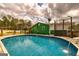 A pristine in-ground pool with a wooden deck, with the home and wooded area in the background at 168 Lakeview Dr, Grantville, GA 30220