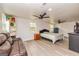 Recreation room featuring hardwood floors, ceiling fans, and a leather couch at 168 Lakeview Dr, Grantville, GA 30220