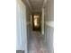 Long, unfinished hallway with drywall, showcasing the layout and potential of the new home at 543 Courthouse Park Dr., Temple, GA 30179