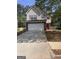 Charming two-story home features a wide driveway and attached two-car garage at 1132 Saint Phillips Ct # 90, Locust Grove, GA 30248