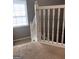 Hallway showcasing stairs with white railings leading to upper level at 1132 Saint Phillips Ct # 90, Locust Grove, GA 30248