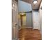 Hallway features wood-look flooring and access to the staircase at 1132 Saint Phillips Ct # 90, Locust Grove, GA 30248