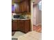 View of dark wood kitchen cabinets and vinyl flooring at 1132 Saint Phillips Ct # 90, Locust Grove, GA 30248
