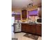 Kitchen area showcases dark wood cabinetry and an opening to the living room at 1132 Saint Phillips Ct # 90, Locust Grove, GA 30248