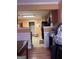 View of the kitchen and adjacent hallway featuring tile flooring and brown cabinets at 1132 Saint Phillips Ct # 90, Locust Grove, GA 30248