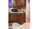 View of kitchen counter space, dark wood cabinets and vinyl flooring at 1132 Saint Phillips Ct # 90, Locust Grove, GA 30248