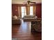Bright living room featuring hardwood floors, comfortable seating, and natural light through the windows at 1132 Saint Phillips Ct # 90, Locust Grove, GA 30248