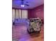 Well-lit living room with hardwood floors, comfortable sofa, and patterned armchair at 1132 Saint Phillips Ct # 90, Locust Grove, GA 30248