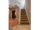 Foyer features carpeted staircase and wood-look flooring at 1132 Saint Phillips Ct # 90, Locust Grove, GA 30248