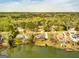 Aerial view of a community of lakeside homes surrounded by beautiful trees at 170 Austin Oaks Dr, Ellenwood, GA 30294