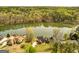 Stunning aerial view of waterfront home surrounded by lush trees and expansive lake at 170 Austin Oaks Dr, Ellenwood, GA 30294