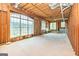 Unfinished basement with a large window and exposed wooden beams overlooking a lake at 170 Austin Oaks Dr, Ellenwood, GA 30294