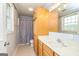 Bright bathroom with a shower and tub combination, vanity, and natural light from the window at 170 Austin Oaks Dr, Ellenwood, GA 30294